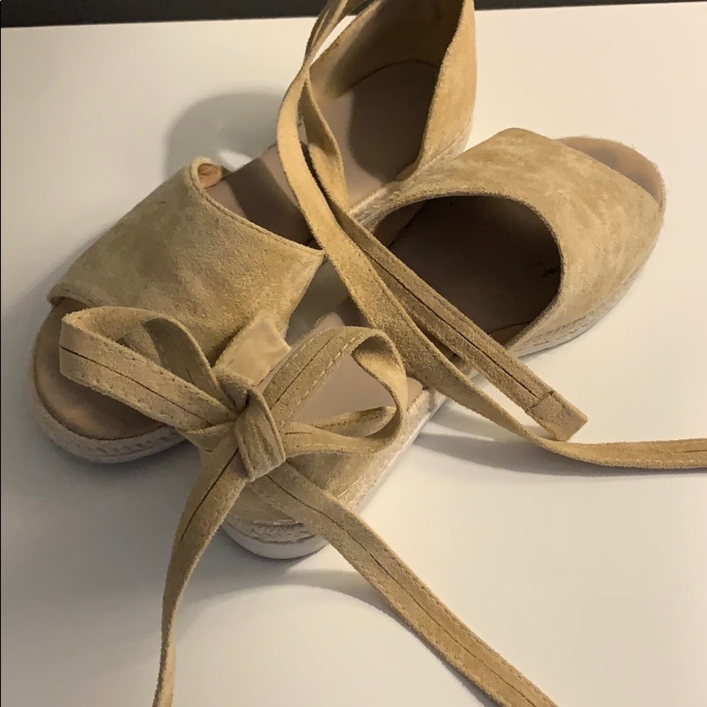 Two shoes. One pair black. One pair tan